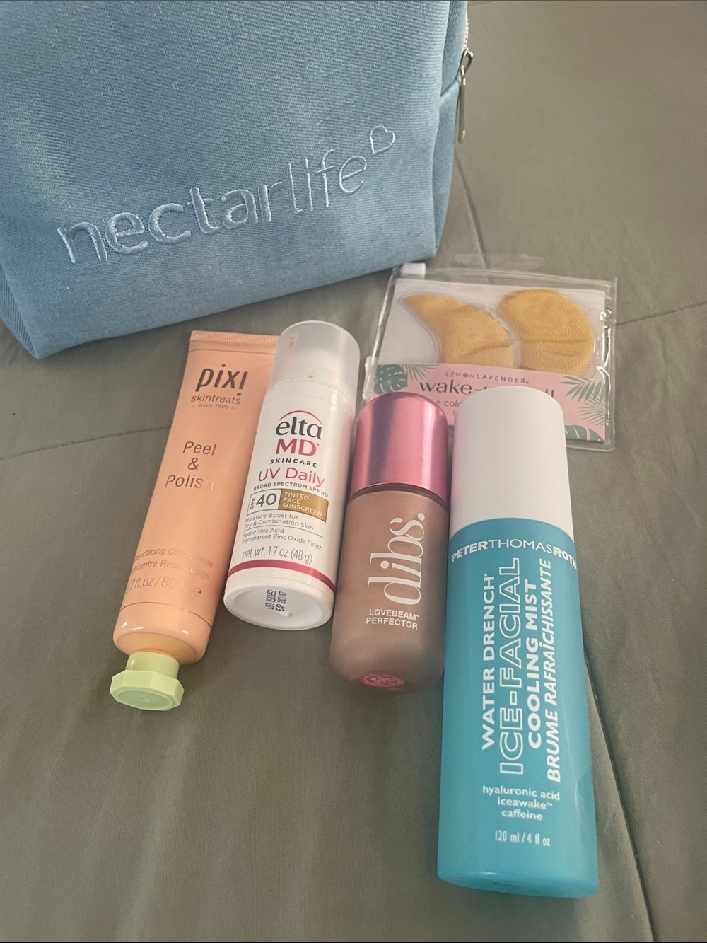 EltaMD Blue Makeup & Skincare Travel Pouch with Assorted Beauty Products
